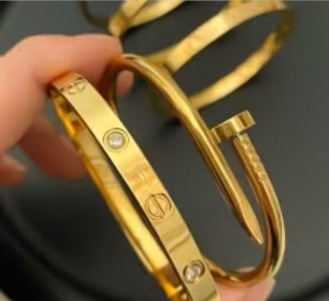 Gold gemstone Cartier and nail bangle set