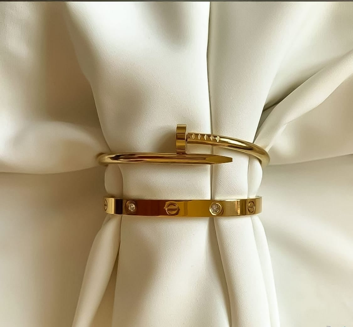 Gold gemstone Cartier and nail bangle set