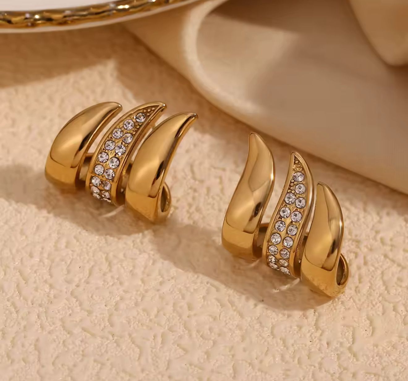 "Gold Wave Earrings with Crystals"