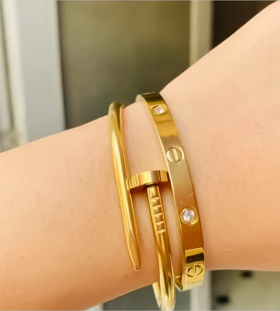 Gold gemstone Cartier and nail bangle set